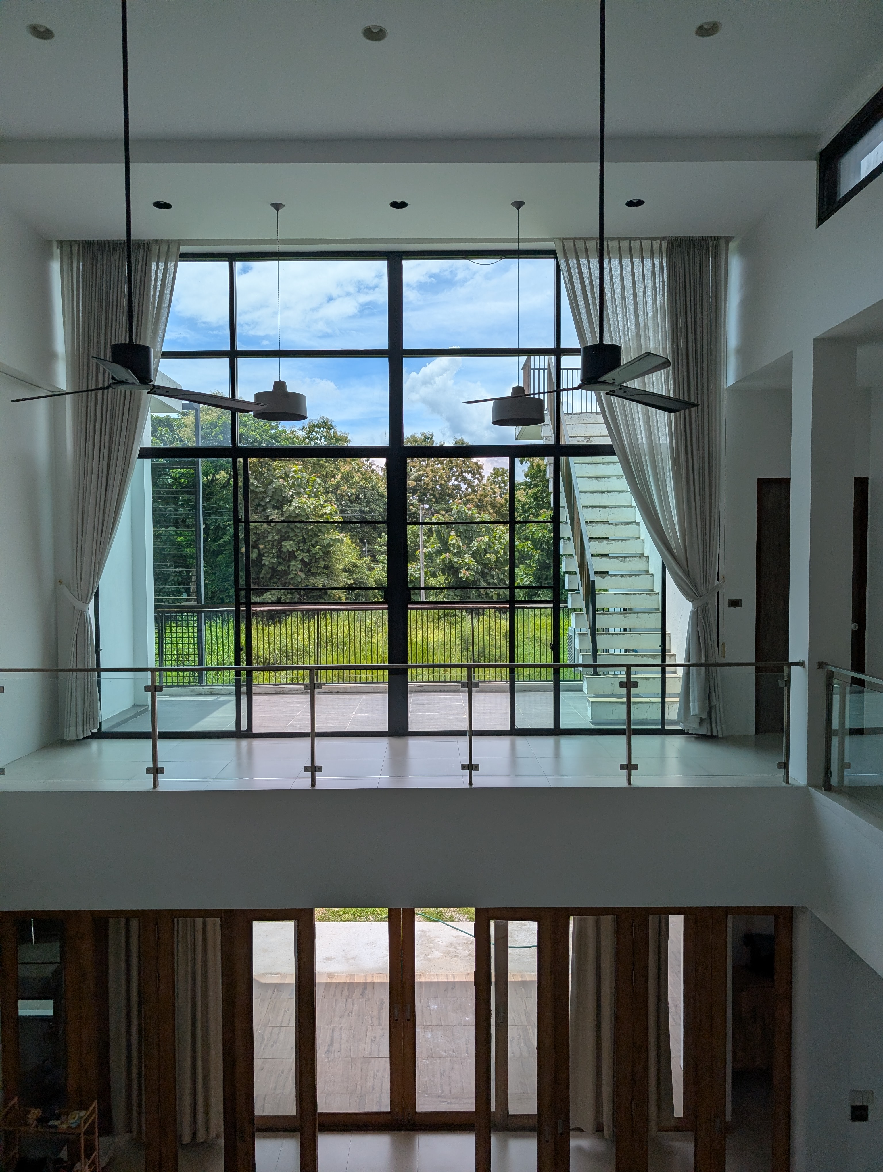 Upstairs landing with large windows and a green outlook